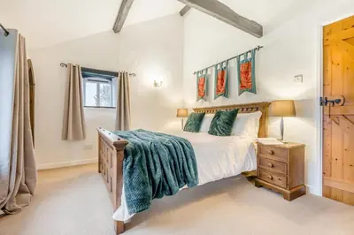 a bedroom with a large bed and a night stand at 1 Bed in St. Gennys oc-l34629 in Crackington Haven