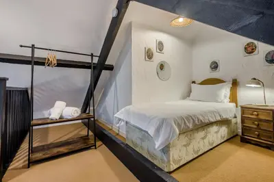 a room with a bed and a staircase in it at 2 Bed in St. Gennys oc-p34632 in Crackington Haven
