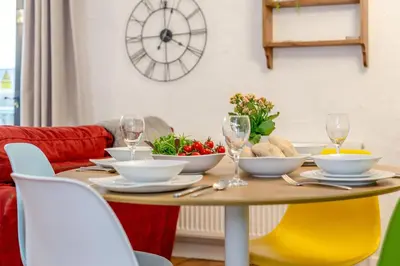 a dining room table with dishes and wine glasses at 3 Bed in St. Gennys oc-a34633 in Crackington Haven