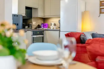 a living room with a table with plates on it at 3 Bed in St. Gennys oc-a34633 in Crackington Haven