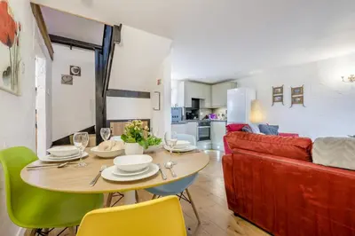 a living room with a table and a red couch at 3 Bed in St. Gennys oc-a34633 in Crackington Haven