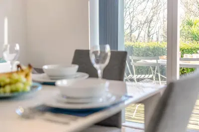 a table with two glasses and a plate of food at 2 Bed in St. Ives oc-t34467 in St Ives