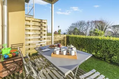 a table and chairs on a patio in a yard at 2 Bed in St. Ives oc-t34467 in St Ives