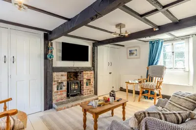 a living room with a fireplace and a tv at 1 Bed in Looe oc-l30002 in Looe