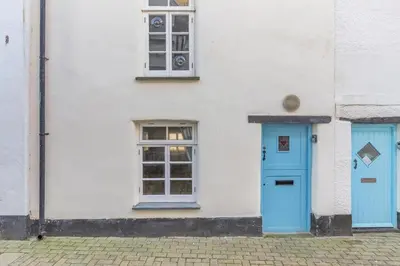 a white building with blue doors and windows at 1 Bed in Looe oc-l30002 in Looe