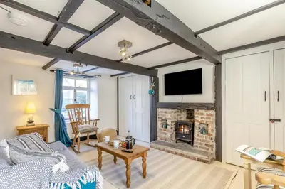 a living room with a couch and a fireplace at 1 Bed in Looe oc-l30002 in Looe