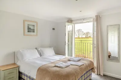 a bedroom with a bed with two towels on it at 4 Bed in Newquay oc-s34623 in Saint Columb Major