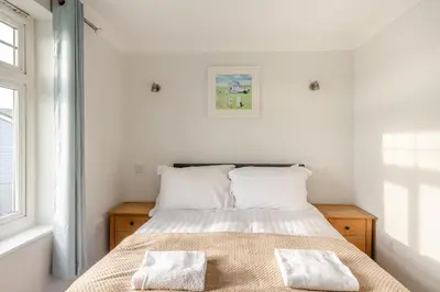 a bedroom with a bed with two towels on it at 4 Bed in Newquay oc-s34623 in Saint Columb Major