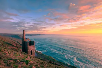 an old building on a hill next to the ocean at 4 Bed in Newquay oc-s34623 in Saint Columb Major