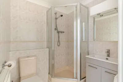a bathroom with a shower and a toilet and a sink at 4 Bed in Newquay oc-s34623 in Saint Columb Major