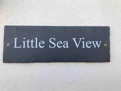 a sign that reads little sea view hanging on a wall at Little Sea View Duporth - 3 bed, gated beach, Nr Eden Project in Charlestown