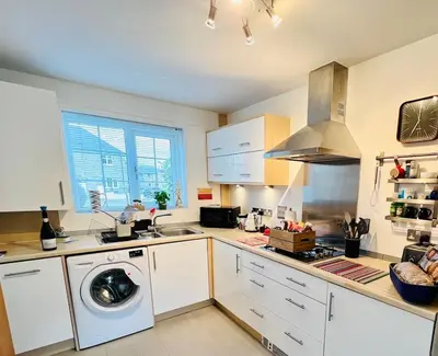 a kitchen with a washing machine and a sink at Little Sea View Duporth - 3 bed, gated beach, Nr Eden Project in Charlestown