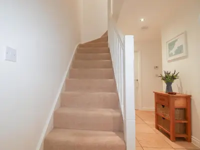 a staircase in a home with a stair case at Blissful Ocean Breeze in Perranporth