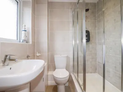 a bathroom with a toilet and a sink and a shower at Blissful Ocean Breeze in Perranporth