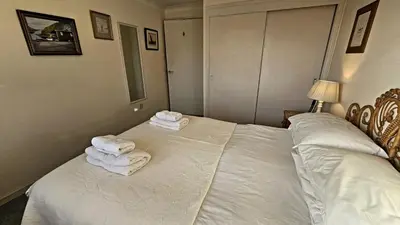 a bedroom with two beds with white towels on them at Little Egret in Saint Mawes
