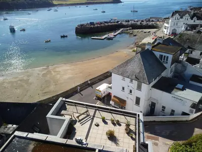 an aerial view of a beach with boats in the water at Little Egret in Saint Mawes