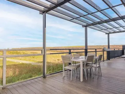 a table and chairs on a deck with a view at South Crofty - The Residence in Redruth