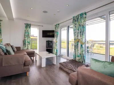 a living room with a couch and a table at South Crofty - The Residence in Redruth