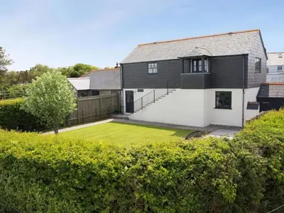 a house with a lawn in front of it at The Granary, Engollan in Wadebridge