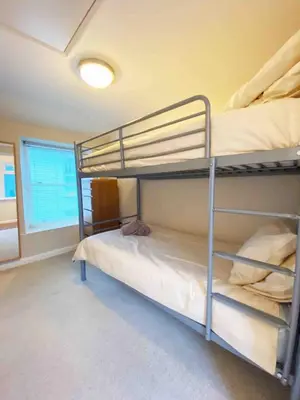 two bunk beds in a room with a window at Seaside Cottage Ideal for Families and Surfers in St Ives