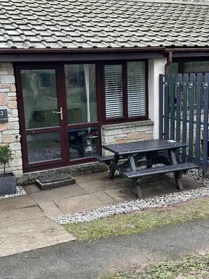 a picnic table sitting in front of a building at The Artist's Cottage in Uny Lelant