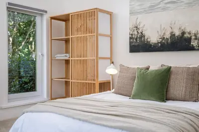 a bedroom with a bed and a book shelf at Beautiful Perranporth country house near the beach in Perranzabuloe
