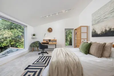 a bedroom with a bed and a desk and a window at Beautiful Perranporth country house near the beach in Perranzabuloe