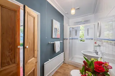 a bathroom with a white tub and a sink at Beautiful Perranporth country house near the beach in Perranzabuloe