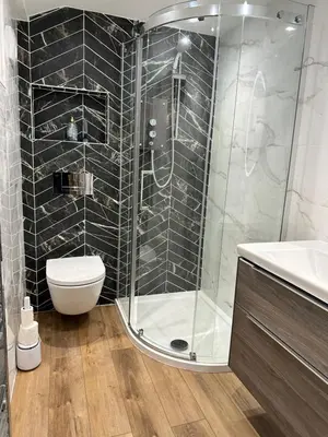 a bathroom with a shower and a toilet and a sink at Kerris Cottage in St Ives