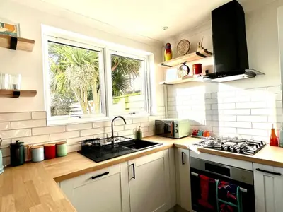 a kitchen with a sink and a window at 3-Bedroom Holiday Home, Newquay with Garden & Parking - 150 Steps to the Beach! in Newquay
