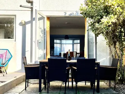 a dining table and chairs in a house at 3-Bedroom Holiday Home, Newquay with Garden & Parking - 150 Steps to the Beach! in Newquay