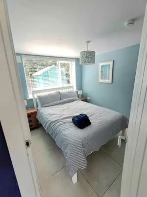 a bed in a bedroom with a blue wall at Ocean Blue in Saint Martin