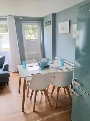 a kitchen and dining room with a table and chairs at Ocean Blue in Saint Martin