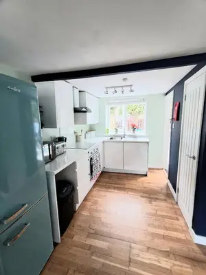 a kitchen with a refrigerator and a sink in it at Ocean Blue in Saint Martin