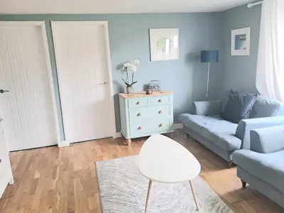 a living room with a couch and a chair at Ocean Blue in Saint Martin