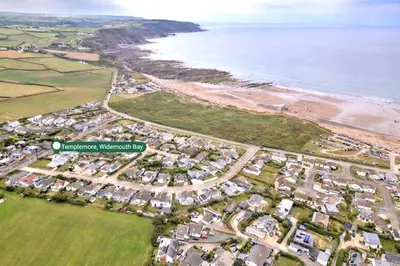 an aerial view of the beach and houses at Finest Retreats - Templemore in Widemouth Bay
