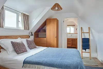 a bedroom with a bed with a blue blanket at Finest Retreats - Templemore in Widemouth Bay