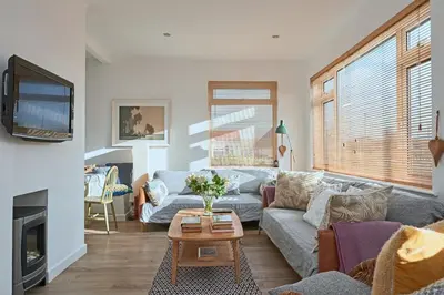 a living room with a couch and a table at Finest Retreats - Templemore in Widemouth Bay