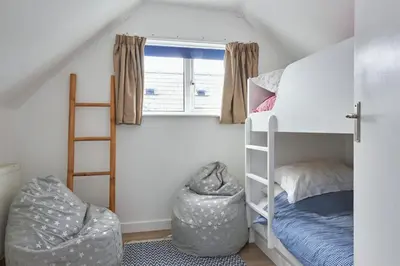 a dorm room with a bunk bed and a ladder at Finest Retreats - Templemore in Widemouth Bay