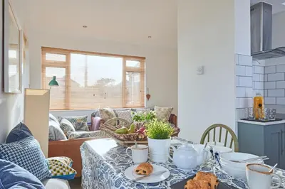 a living room with a table with food on it at Finest Retreats - Templemore in Widemouth Bay