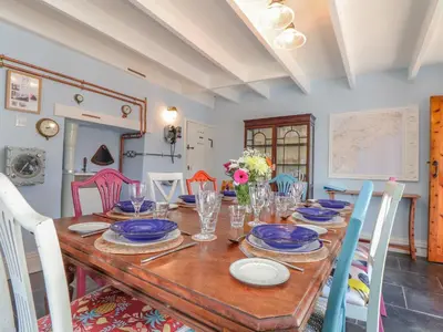 a dining room table with blue and white plates at Trewenna in Tregoney