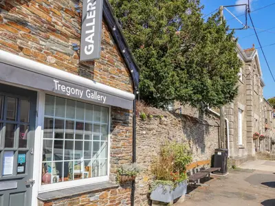 a brick building with a sign for a therapy gallery at Trewenna in Tregoney