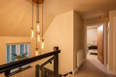 a hallway of a home with a stairway at Treallen Rock in Saint Minver