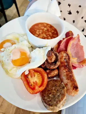 a plate of breakfast food with eggs bacon beans and beans at St Moritz Hotel and Cowshed Spa in Polzeath