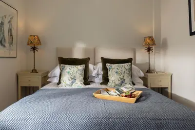 a bed with a tray of food on top of it at Easy Oars - Flushing, Falmouth in Flushing