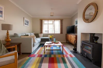 a living room with a couch and a table at Easy Oars - Flushing, Falmouth in Flushing