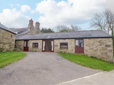 a stone house with a driveway in front of it at Little Tregarrick in Helston