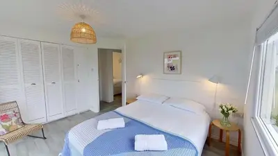 a bedroom with a bed with two towels on it at D05 Cedrica, Riviere Towans in Hayle