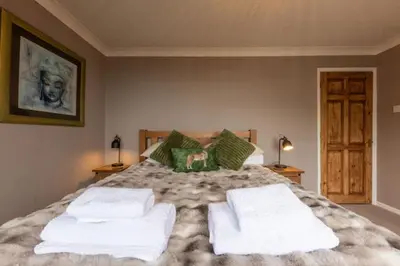 a bedroom with a large bed with towels on it at Looe sea view sleeps 2 free parking in Looe