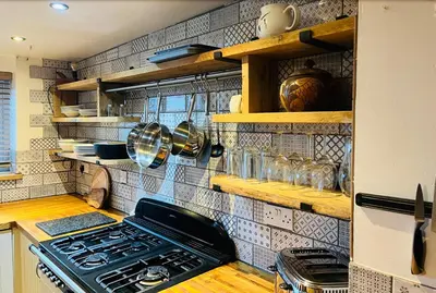 a kitchen with a stove top oven in a kitchen at Looe sea view sleeps 2 free parking in Looe